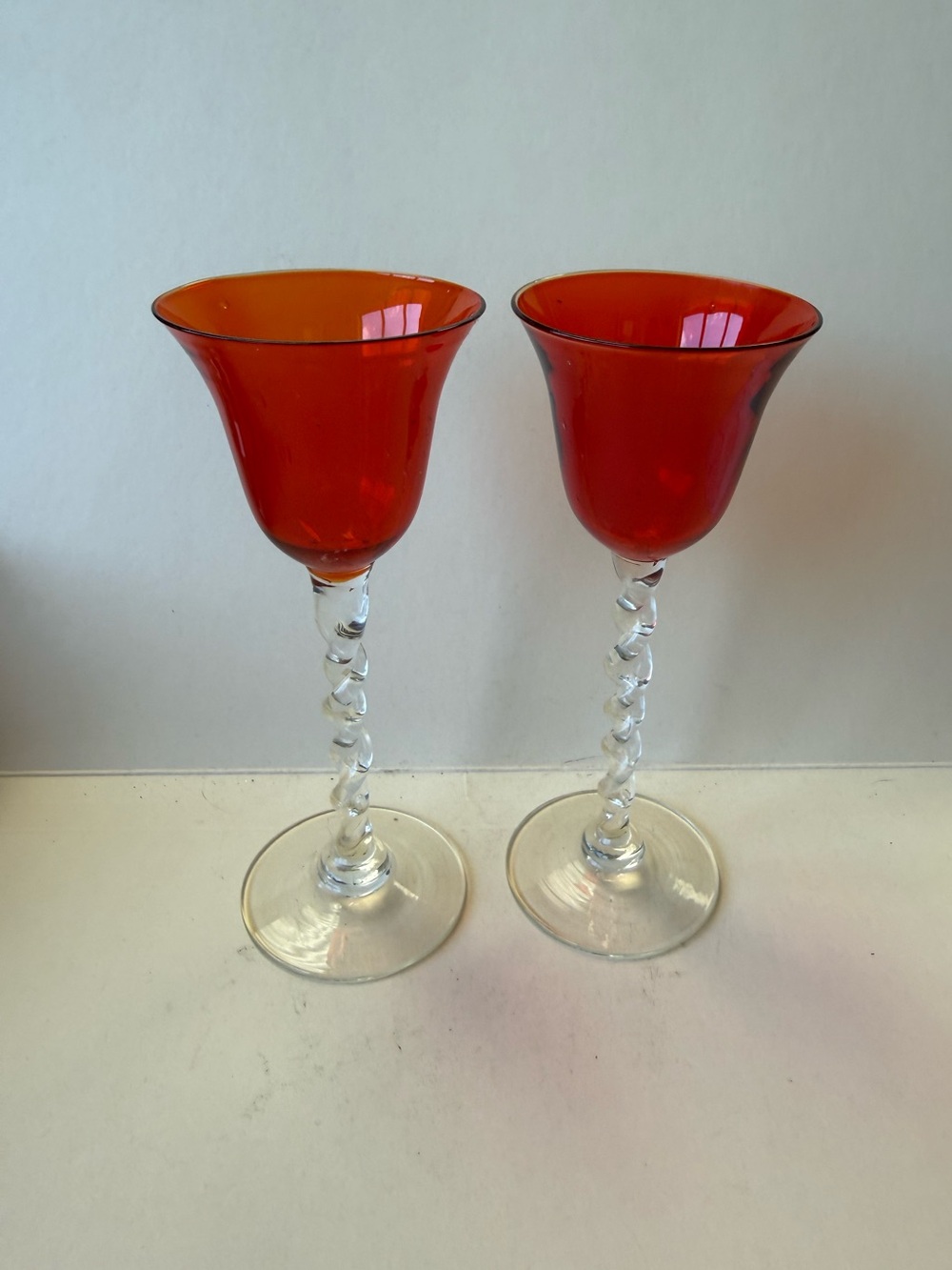 Vintage Pair of Orangy Red Apertif Glassware with Clear Twisted Stems.